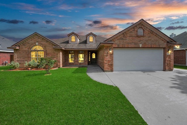 204 Audubon Woods Ct, Richwood, TX 77531 - view of front of house with driveway, brick siding, a yard, an attached garage, and roof with shingles