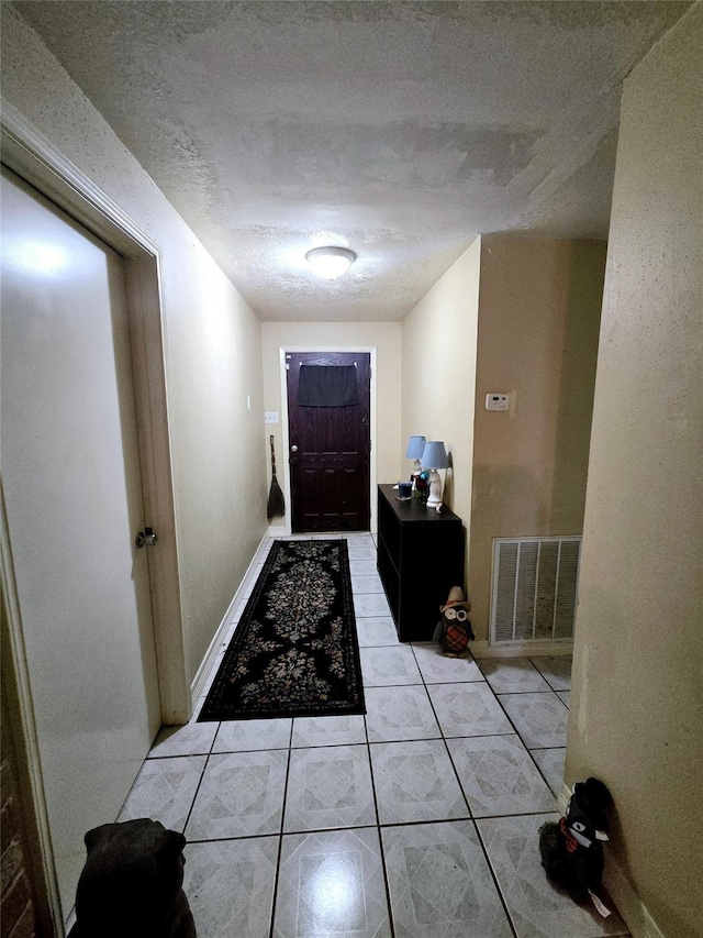 17415 Mallett St, Crosby, TX 77532 - doorway to outside with light tile patterned floors and a textured ceiling