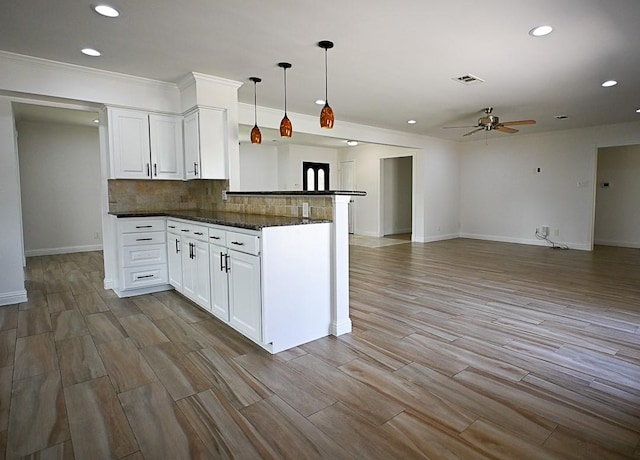 5035 Yarwell Dr, Houston, TX 77096 - kitchen with ceiling fan, recessed lighting, white cabinetry, tasteful backsplash, and hanging light fixtures