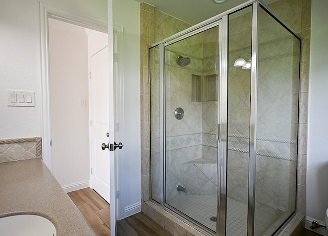 5035 Yarwell Dr, Houston, TX 77096 - bathroom featuring a stall shower, wood finished floors, and vanity