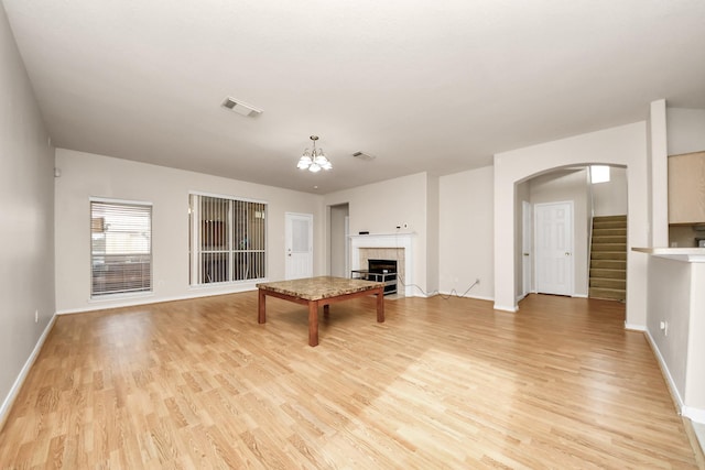 24219 Camillia Ridge Way, Katy, TX 77493 - game room featuring light wood finished floors, arched walkways, a fireplace, and a chandelier