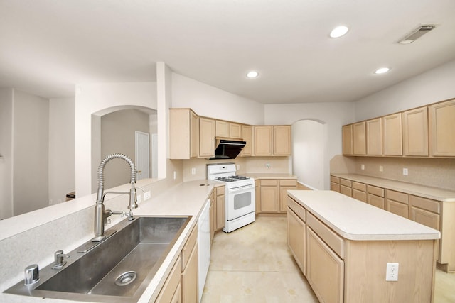24219 Camillia Ridge Way, Katy, TX 77493 - kitchen with white gas range, light brown cabinets, arched walkways, recessed lighting, and light countertops