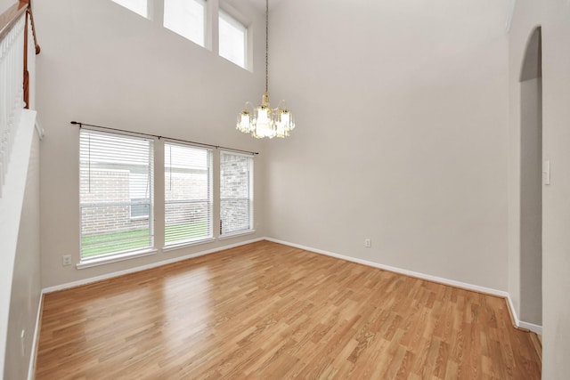24219 Camillia Ridge Way, Katy, TX 77493 - spare room with a chandelier, light wood-type flooring, healthy amount of natural light, and a high ceiling