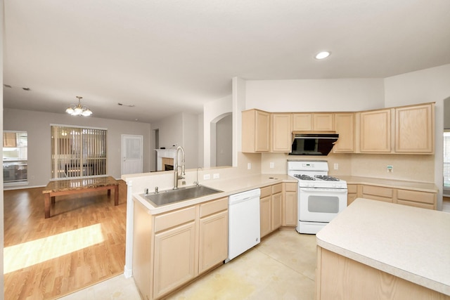 24219 Camillia Ridge Way, Katy, TX 77493 - kitchen featuring white appliances, light brown cabinetry, light countertops, a chandelier, and a peninsula