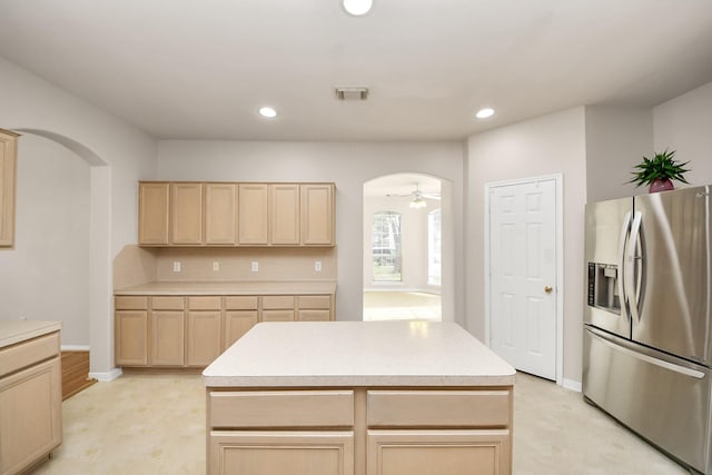 24219 Camillia Ridge Way, Katy, TX 77493 - kitchen with stainless steel fridge, light brown cabinets, arched walkways, light countertops, and recessed lighting