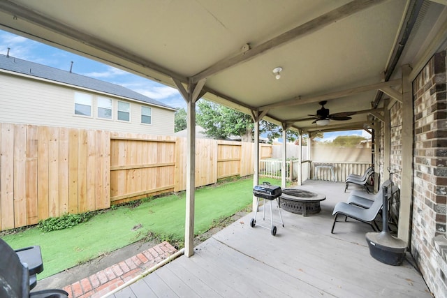 24219 Camillia Ridge Way, Katy, TX 77493 - fenced backyard with a deck, a fire pit, a ceiling fan, and area for grilling