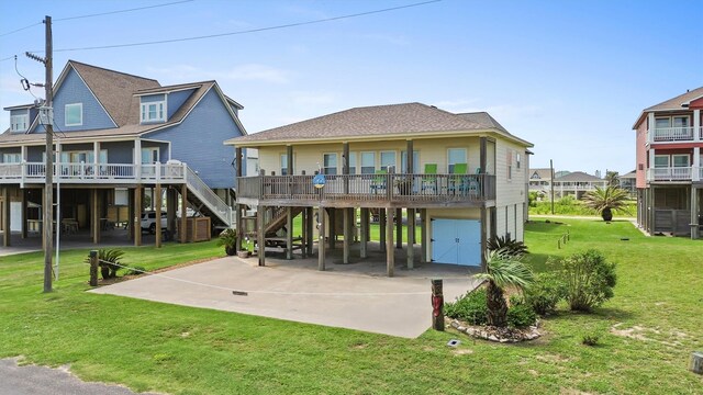 2577 Holiday Dr, Crystal Beach, TX 77650 - rear view of property featuring a carport, a yard, and concrete driveway