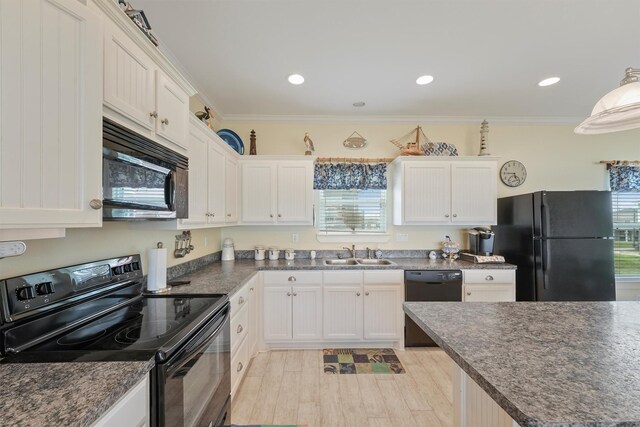 2577 Holiday Dr, Crystal Beach, TX 77650 - kitchen featuring black appliances, plenty of natural light, white cabinetry, light wood-style flooring, and crown molding