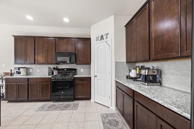 9127 Sasson Blvd, Houston, TX 77044 - kitchen with black appliances, dark brown cabinetry, tasteful backsplash, light stone counters, and light tile patterned floors
