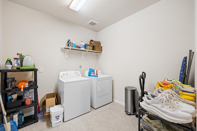 9127 Sasson Blvd, Houston, TX 77044 - laundry room featuring washer and dryer and light tile patterned floors