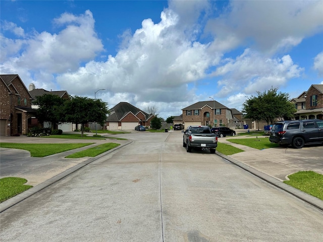 22411 Limestone Crest Ln, Katy, TX 77449 - view of concrete street with a residential view, street lights, curbs, and sidewalks