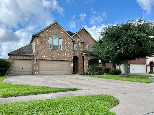22411 Limestone Crest Ln, Katy, TX 77449 - traditional-style home with brick siding, driveway, a shingled roof, an attached garage, and a front lawn