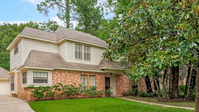 17718 Terrawren Ln, Spring, TX 77379 - view of front of property featuring brick siding, a front lawn, a shingled roof, a garage, and stucco siding