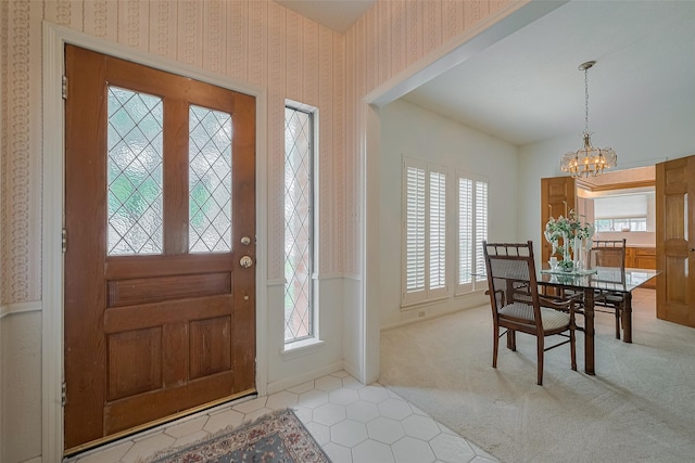 17718 Terrawren Ln, Spring, TX 77379 - foyer featuring wallpapered walls, a chandelier, plenty of natural light, and light carpet