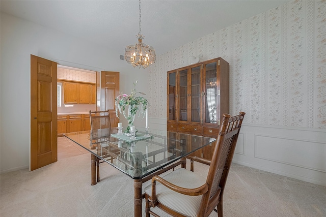 17718 Terrawren Ln, Spring, TX 77379 - dining room featuring a chandelier, wainscoting, light colored carpet, plenty of natural light, and wallpapered walls