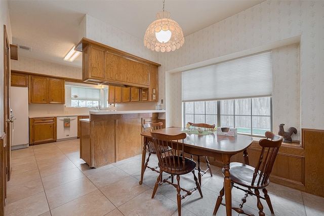 17718 Terrawren Ln, Spring, TX 77379 - dining area featuring wallpapered walls, plenty of natural light, light tile patterned floors, and wainscoting