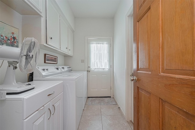 17718 Terrawren Ln, Spring, TX 77379 - laundry area featuring cabinet space, washer and clothes dryer, and light tile patterned flooring