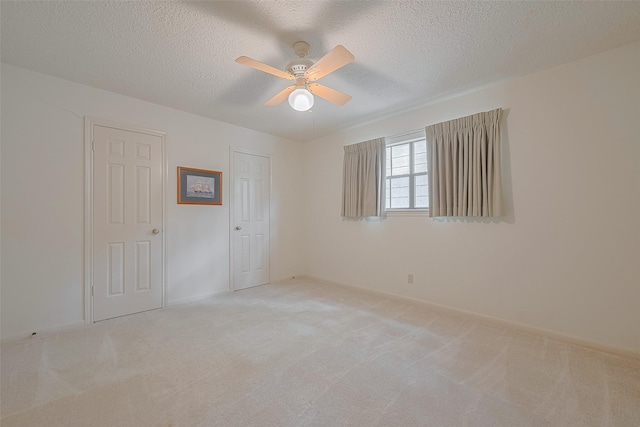 17718 Terrawren Ln, Spring, TX 77379 - spare room featuring light carpet, ceiling fan, and a textured ceiling