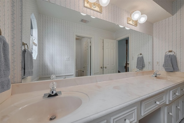 17718 Terrawren Ln, Spring, TX 77379 - bathroom featuring wallpapered walls and double vanity