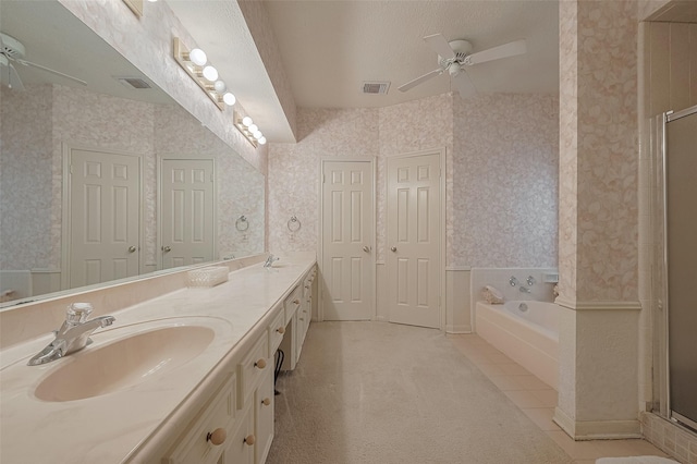 17718 Terrawren Ln, Spring, TX 77379 - full bathroom featuring ceiling fan, wallpapered walls, double vanity, a garden tub, and a stall shower