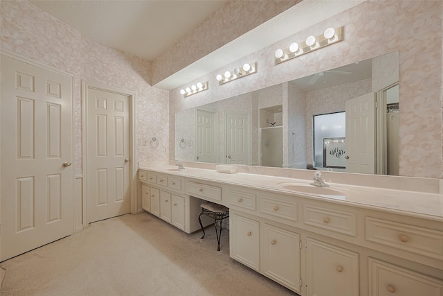 17718 Terrawren Ln, Spring, TX 77379 - bathroom featuring wallpapered walls, double vanity, a shower with door, and ceiling fan