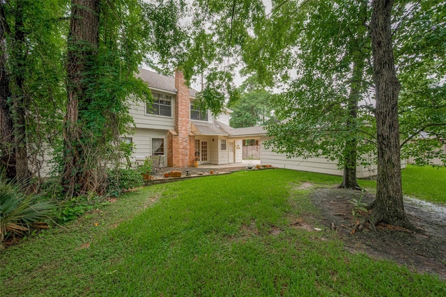 17718 Terrawren Ln, Spring, TX 77379 - view of front of house with a front yard, a chimney, and a patio area