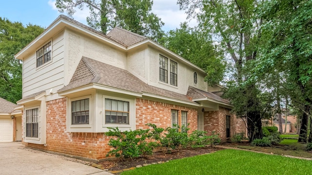 17718 Terrawren Ln, Spring, TX 77379 - view of front of property featuring brick siding, a garage, driveway, and a shingled roof