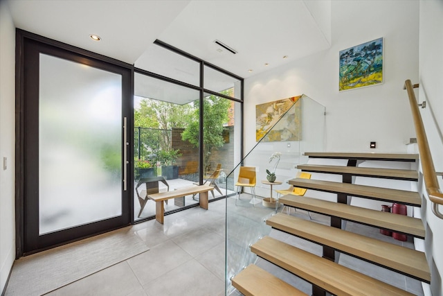 2332 Wroxton Rd, Houston, TX 77005 - stairs featuring a wall of windows and tile patterned flooring