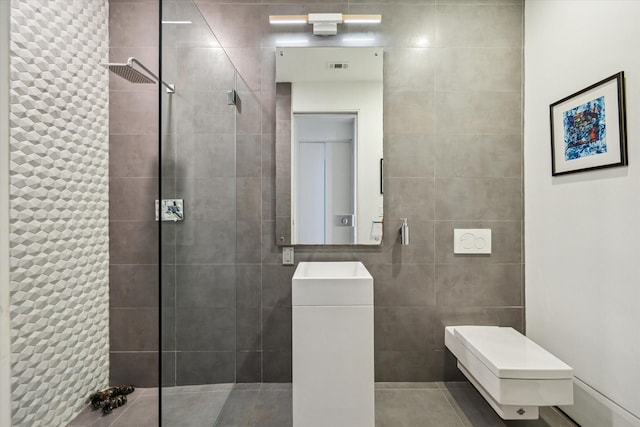 2332 Wroxton Rd, Houston, TX 77005 - bathroom featuring tile walls, a tile shower, tile patterned flooring, and vanity