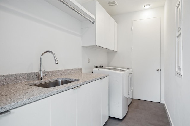 2332 Wroxton Rd, Houston, TX 77005 - laundry area featuring cabinet space and separate washer and dryer