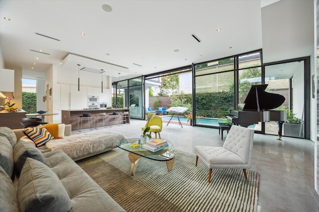 2332 Wroxton Rd, Houston, TX 77005 - living room with expansive windows and concrete floors
