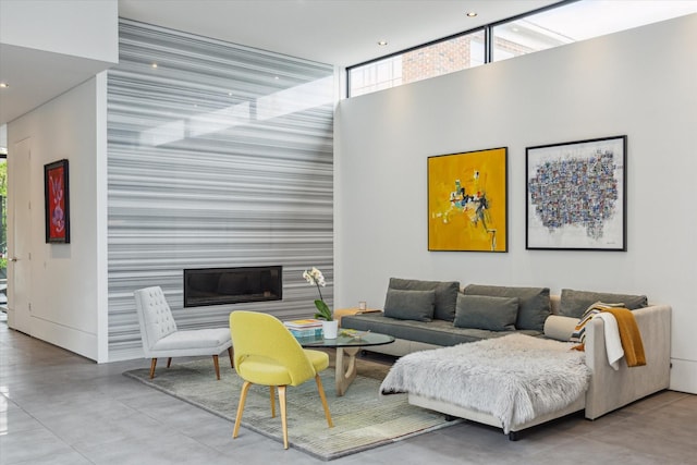 2332 Wroxton Rd, Houston, TX 77005 - living room with an accent wall, concrete flooring, recessed lighting, and a towering ceiling