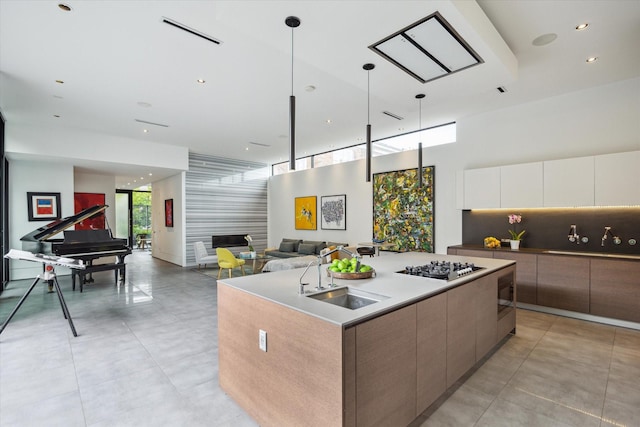 2332 Wroxton Rd, Houston, TX 77005 - kitchen with modern cabinets, open floor plan, a center island with sink, white cabinetry, and recessed lighting