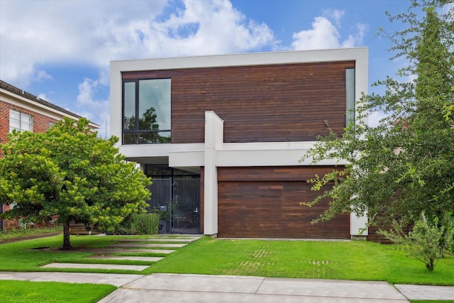 2332 Wroxton Rd, Houston, TX 77005 - contemporary house featuring a balcony and a front lawn