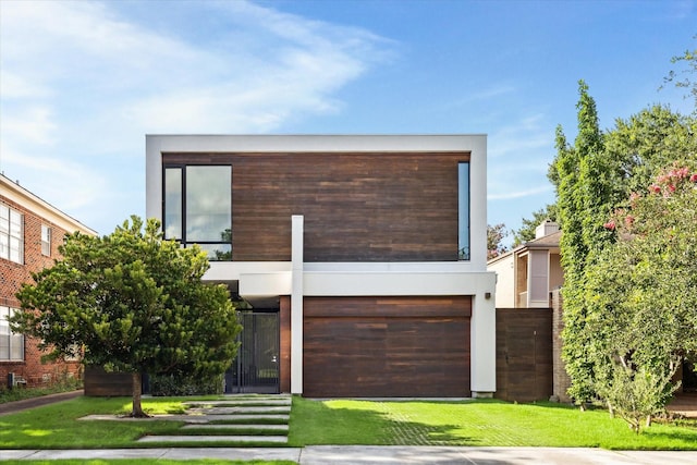 2332 Wroxton Rd, Houston, TX 77005 - modern home featuring a garage, a front yard, and stucco siding