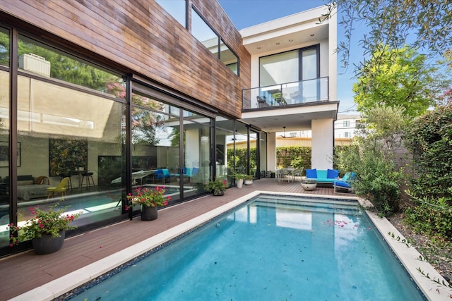 2332 Wroxton Rd, Houston, TX 77005 - back of house featuring an outdoor living space, a wooden deck, a balcony, and an outdoor pool