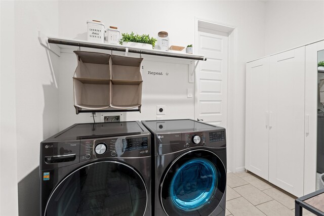2131 Acadian Way, Brookshire, TX 77423 - laundry area featuring washing machine and clothes dryer and light tile patterned flooring