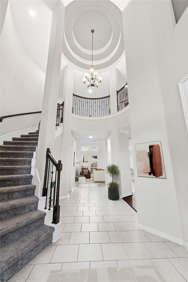 2131 Acadian Way, Brookshire, TX 77423 - foyer entrance featuring a high ceiling, stairs, a chandelier, and light tile patterned floors