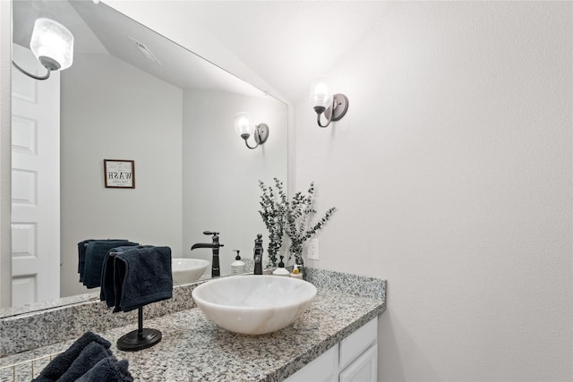 2131 Acadian Way, Brookshire, TX 77423 - bathroom featuring lofted ceiling and vanity