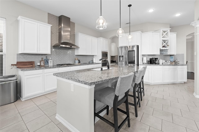 2131 Acadian Way, Brookshire, TX 77423 - kitchen featuring appliances with stainless steel finishes, wall chimney range hood, decorative backsplash, light tile patterned floors, and recessed lighting
