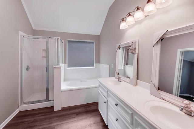 461 Cumberland Trl, Conroe, TX 77302 - bathroom featuring a shower stall, double vanity, a bath, wood finished floors, and vaulted ceiling