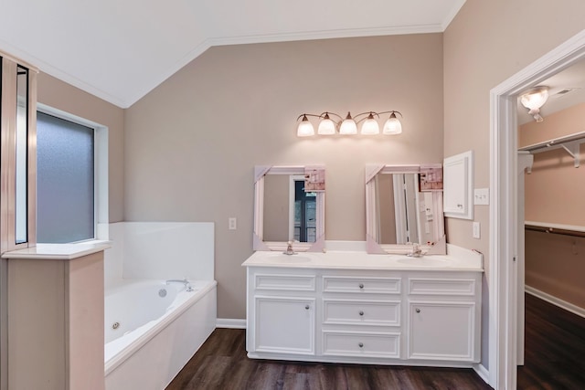 461 Cumberland Trl, Conroe, TX 77302 - full bath with wood finished floors, double vanity, a tub with jets, a walk in closet, and lofted ceiling
