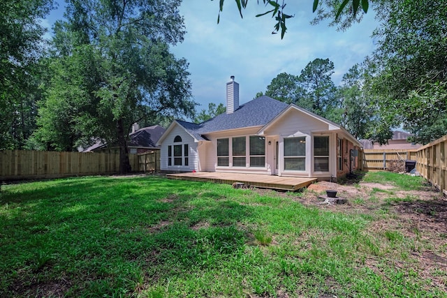 461 Cumberland Trl, Conroe, TX 77302 - back of house with a chimney, a fenced backyard, a deck, and a shingled roof