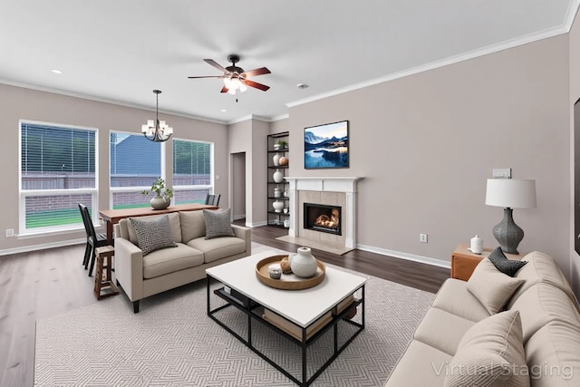 461 Cumberland Trl, Conroe, TX 77302 - living area featuring a ceiling fan, wood finished floors, a chandelier, crown molding, and recessed lighting