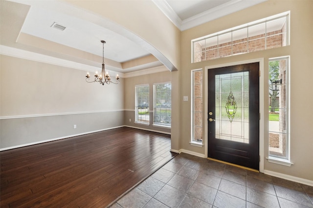 15331 Springhill Bend Ln, Cypress, TX 77429 - foyer featuring healthy amount of natural light, a chandelier, arched walkways, ornamental molding, and dark wood-style flooring