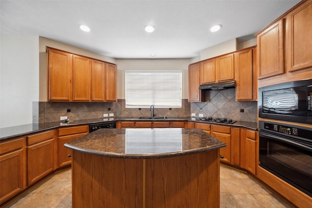 15331 Springhill Bend Ln, Cypress, TX 77429 - kitchen featuring black appliances, under cabinet range hood, light tile patterned floors, a kitchen island, and dark stone counters