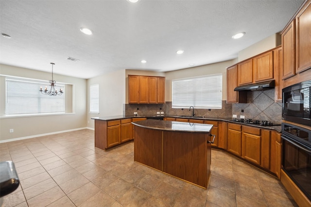 15331 Springhill Bend Ln, Cypress, TX 77429 - kitchen featuring black appliances, dark countertops, tasteful backsplash, brown cabinets, and recessed lighting