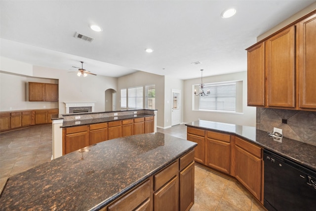 15331 Springhill Bend Ln, Cypress, TX 77429 - kitchen with black dishwasher, a ceiling fan, brown cabinets, a fireplace, and recessed lighting