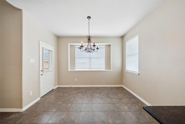 15331 Springhill Bend Ln, Cypress, TX 77429 - unfurnished dining area featuring a chandelier and baseboards