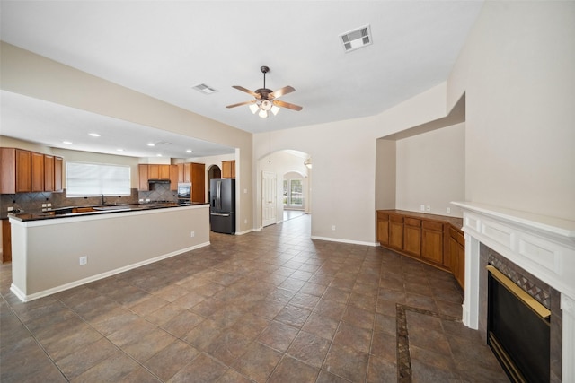 15331 Springhill Bend Ln, Cypress, TX 77429 - unfurnished living room with arched walkways, a ceiling fan, plenty of natural light, a tile fireplace, and recessed lighting